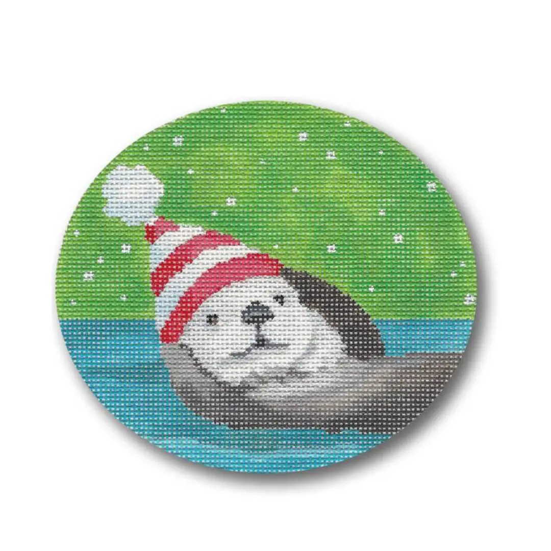 A cross stitch picture of an otter wearing a santa hat created by Cecilia Ohm.