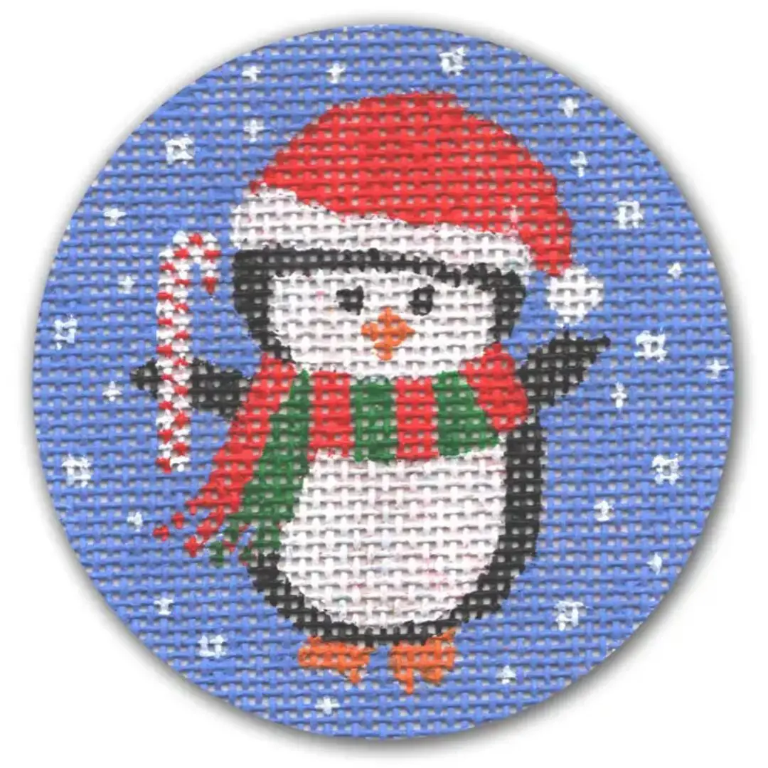 A cross stitch pattern of a penguin holding a candy cane designed by Cecilia Ohm Eriksen.