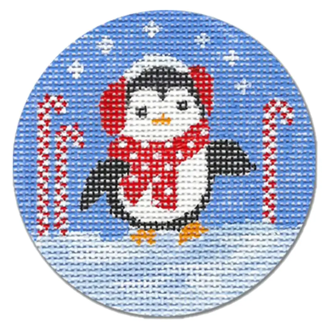 A cross stitch pattern of a penguin with a scarf and candy canes by Cecilia Ohm Eriksen.