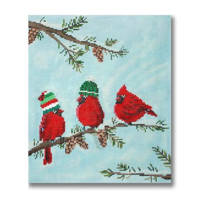 Three red cardinals sitting on a branch with pine cones.