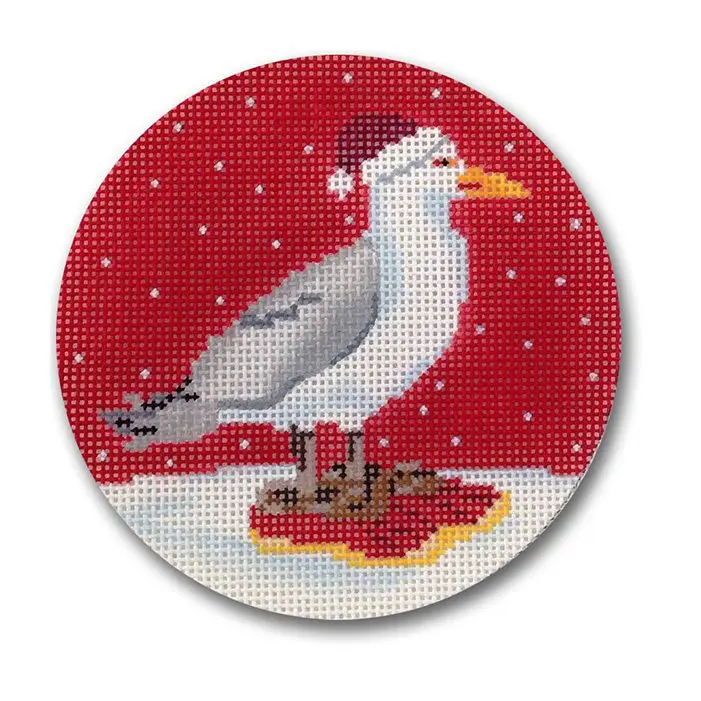 A cross stitch picture of a seagull with a santa hat.