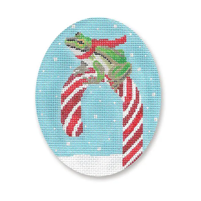A frog sitting on a candy cane.