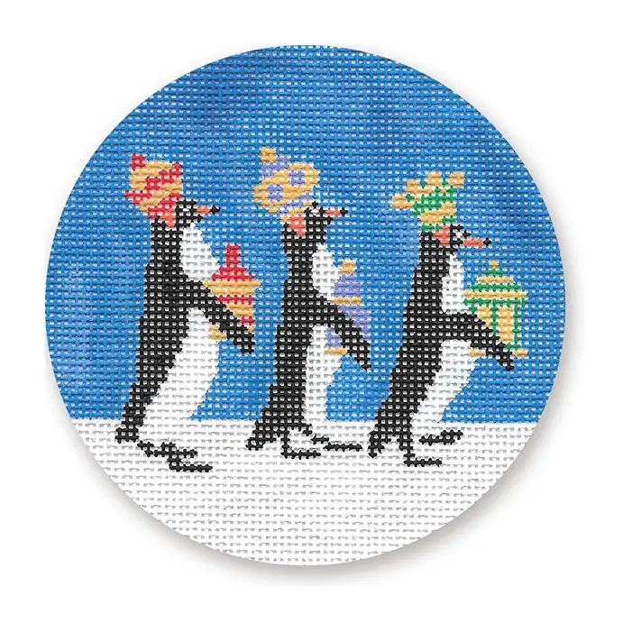 Three penguins with christmas hats on a circle needlepoint canvas.