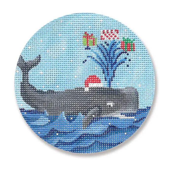 A whale with a santa hat and presents in the water.