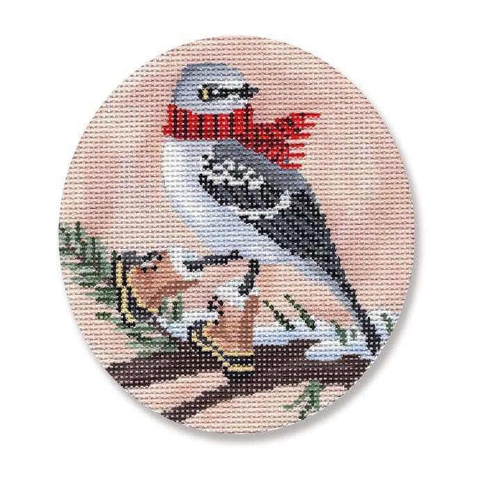 A cross stitch picture of a bird on a branch.