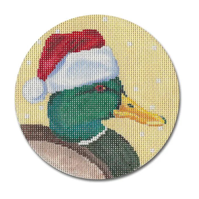 A cross stitch picture of a duck wearing a santa hat.