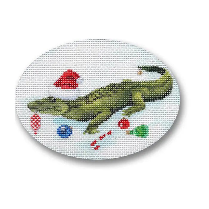 A cross stitch picture of a crocodile with a santa hat.