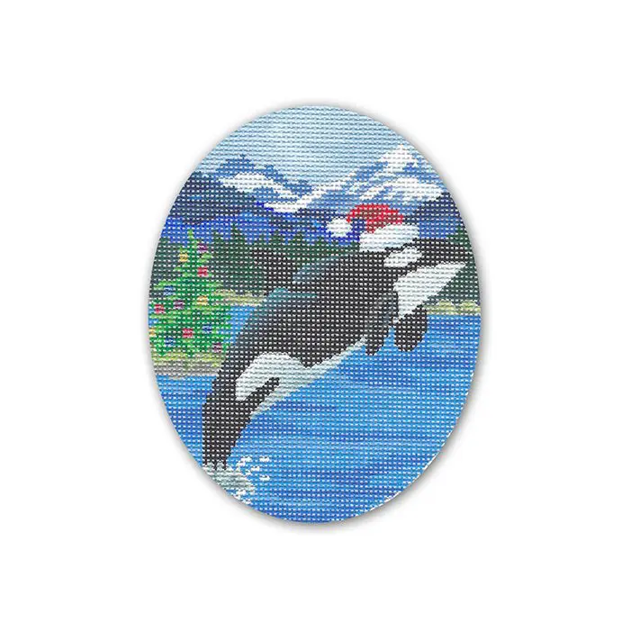 A cross stitch picture of an orca whale with a santa hat.