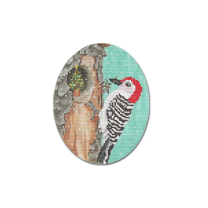 A cross stitch picture of a woodpecker in a nest.