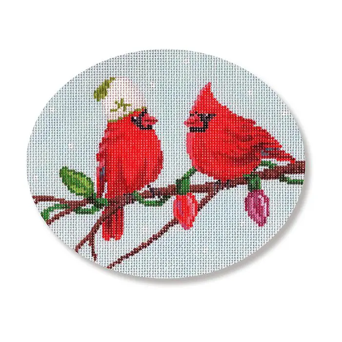 Two red cardinals sitting on a branch.