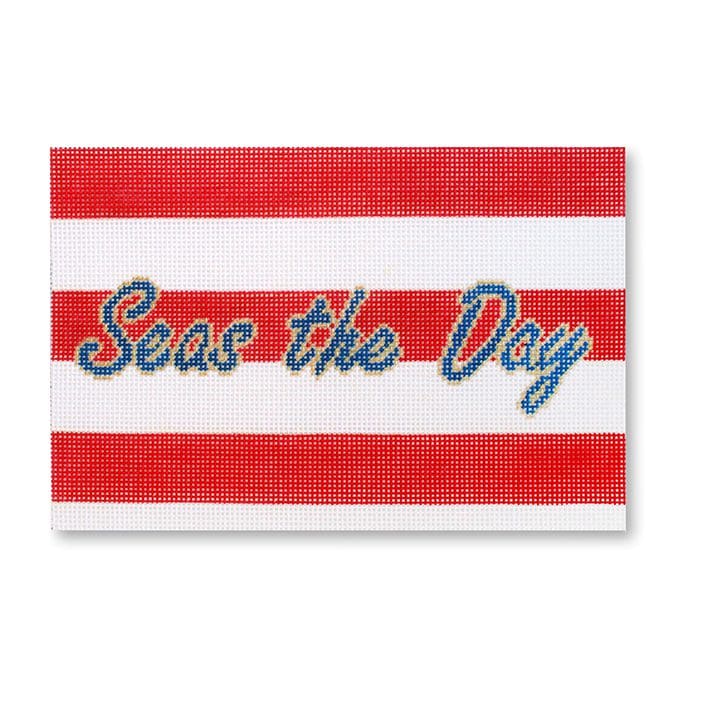 A red and white striped coaster with the words "seas the day" designed by Cecilia Ohm Eriksen.