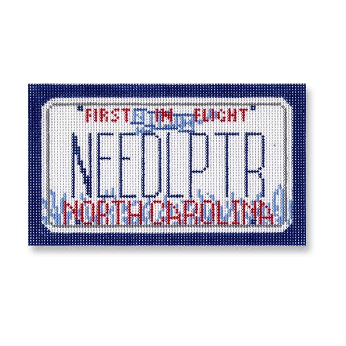 Cecilia Ohm's first flight needlepr cross stitch showcases the iconic North Carolina license plate design.