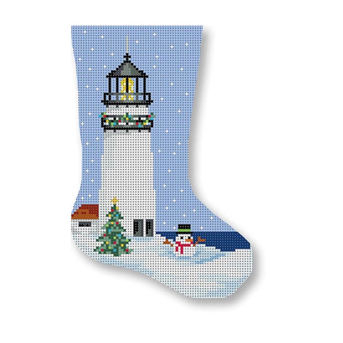 A cross stitch stocking featuring a snowman and lighthouse, created by Cecilia Ohm Eriksen.