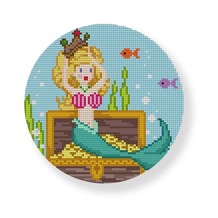 A cross stitch pattern of a mermaid sitting on a chest, designed by Cecilia Ohm.