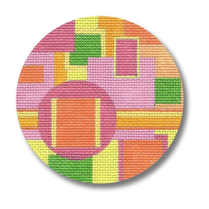 A round button with a pink, yellow, and green design created by Cecilia Eriksen.