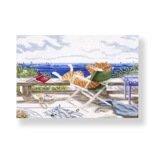 A cross stitch picture from the Ciao Bella Collection featuring two cats sitting on a deck overlooking the ocean.