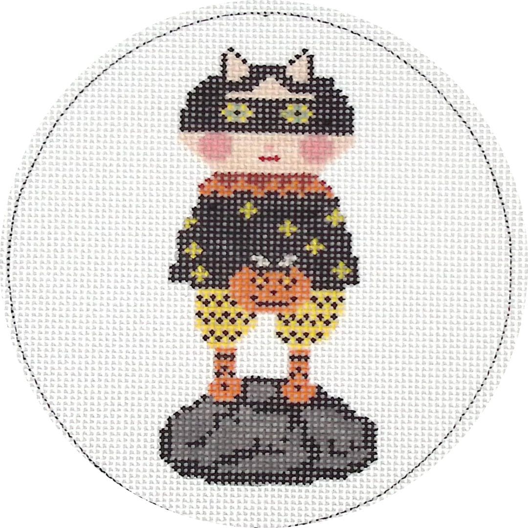 A cross stitch picture of a little girl in a Ciao Bella Collection halloween costume.