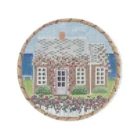 A cross stitch picture of a house with flowers.