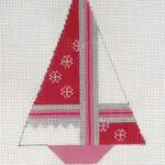 A cross stitch picture of a sailboat.