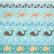 A cross stitch pattern with whales, fish and waves.
