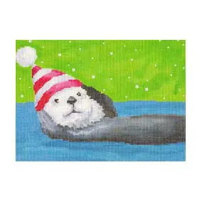 An otter wearing a santa hat in the water.